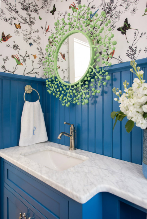 blue-wood-panel-behind-bathroom-sink-wreath-mirror