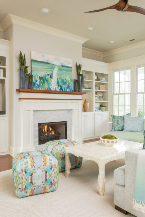 white-fireplace-wooden-mantle-art-colorful-ottomans