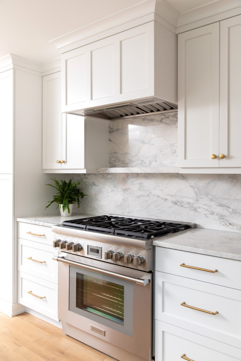 stainless-steel-cooktop-range-white-cabinets-marble-back-splash